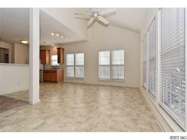 608 Eaton Court Fort Mill, SC 29708 - Photo 12 of 16 a view of an empty room with chandelier fan and kitchen view