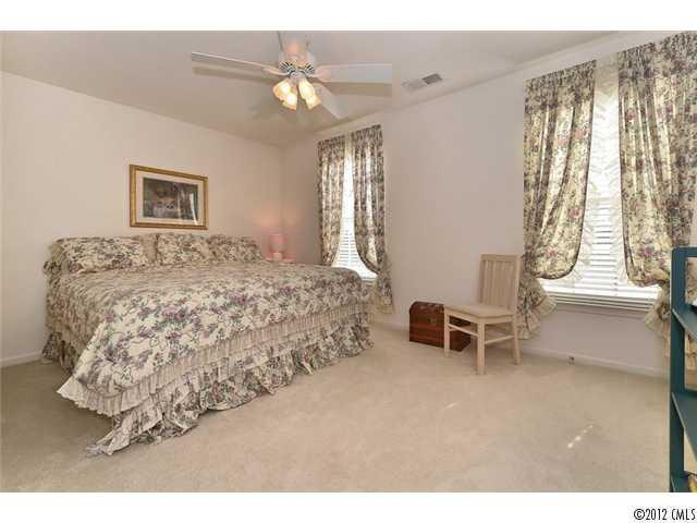 608 Eaton Court Fort Mill, SC 29708 - Photo 15 of 16 a bed room with a bed and a chair