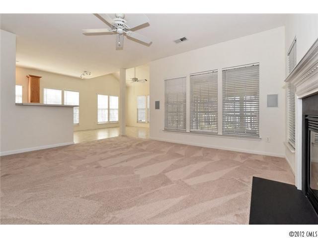 608 Eaton Court Fort Mill, SC 29708 - Photo 5 of 16 a view of an empty room with a window and a kitchen view