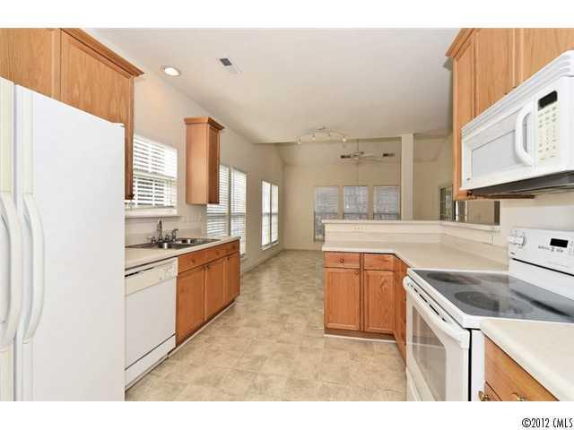 608 Eaton Court Fort Mill, SC 29708 - Photo 10 of 16 a kitchen with stainless steel appliances granite countertop a sink stove and refrigerator