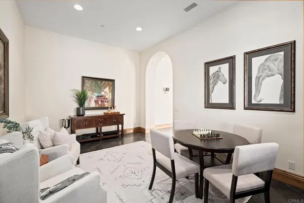 a dining room with furniture a rug and wooden floor