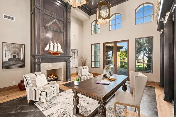 a living room with furniture kitchen and a large window