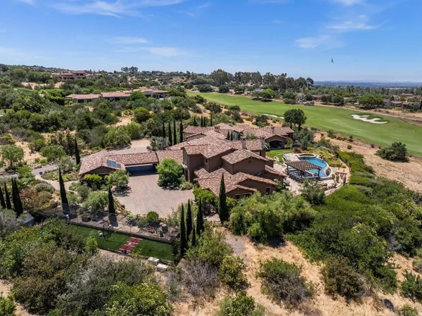 an aerial view of residential houses with outdoor space and river