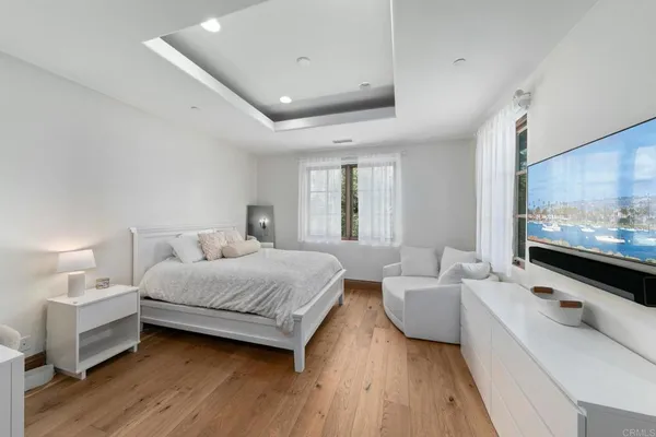 a bedroom with a bed and a large window