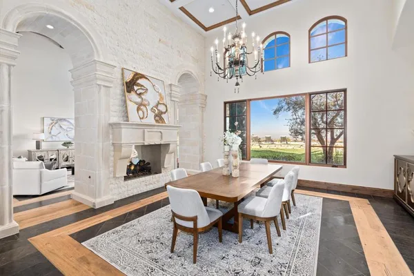 a view of a dining room with furniture a rug and wooden floor
