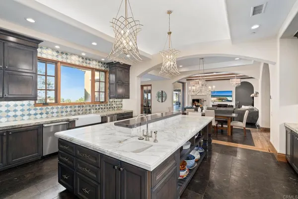 a large kitchen with a table and chairs