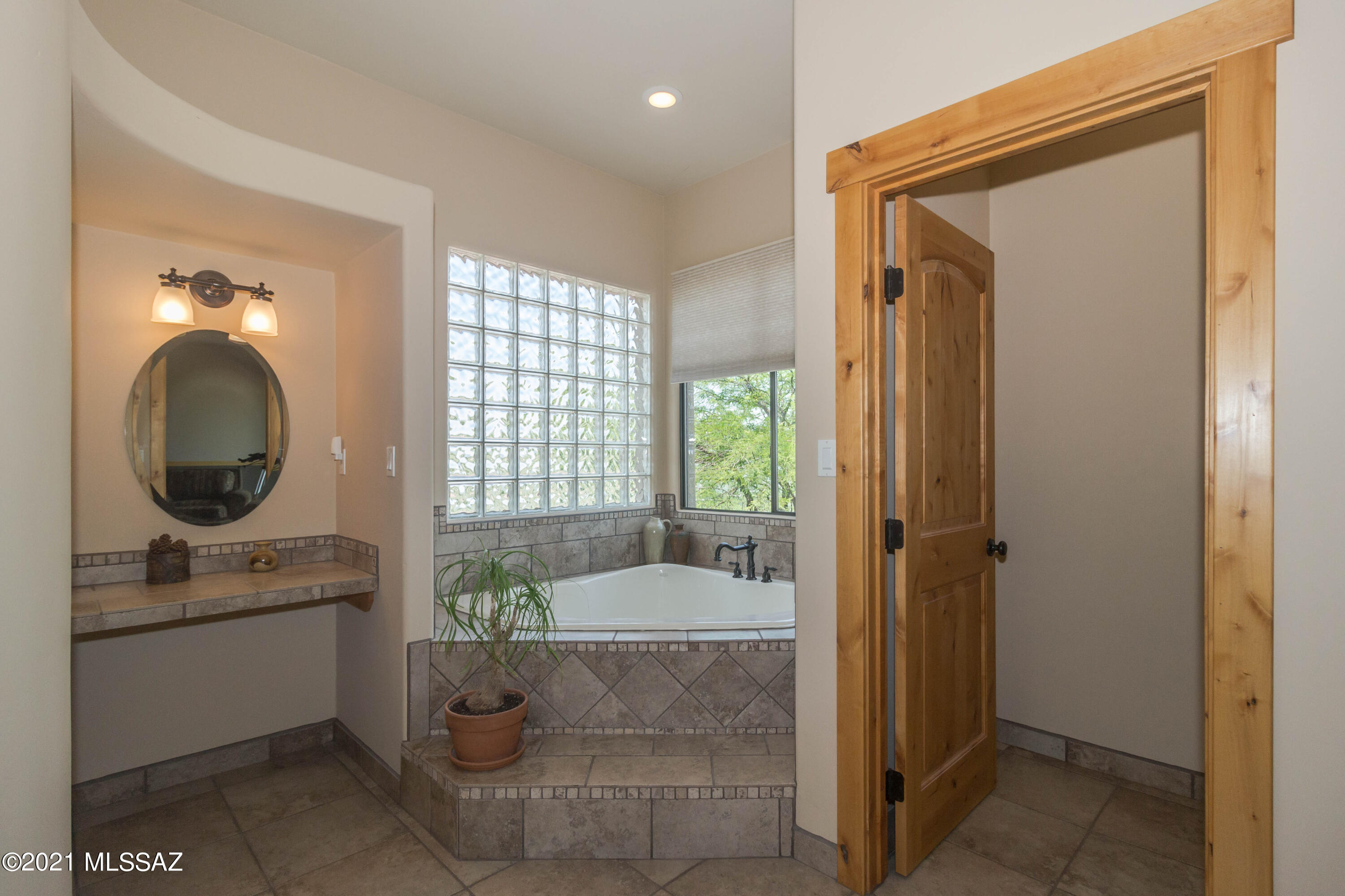 1567 Camino Esturion Rio Rico, AZ 85648 - Photo 34 of 41 a bathroom with a tub sink and mirror