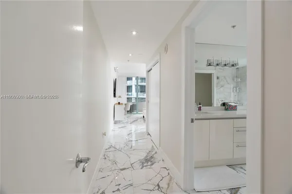 a view of a hallway with bathroom