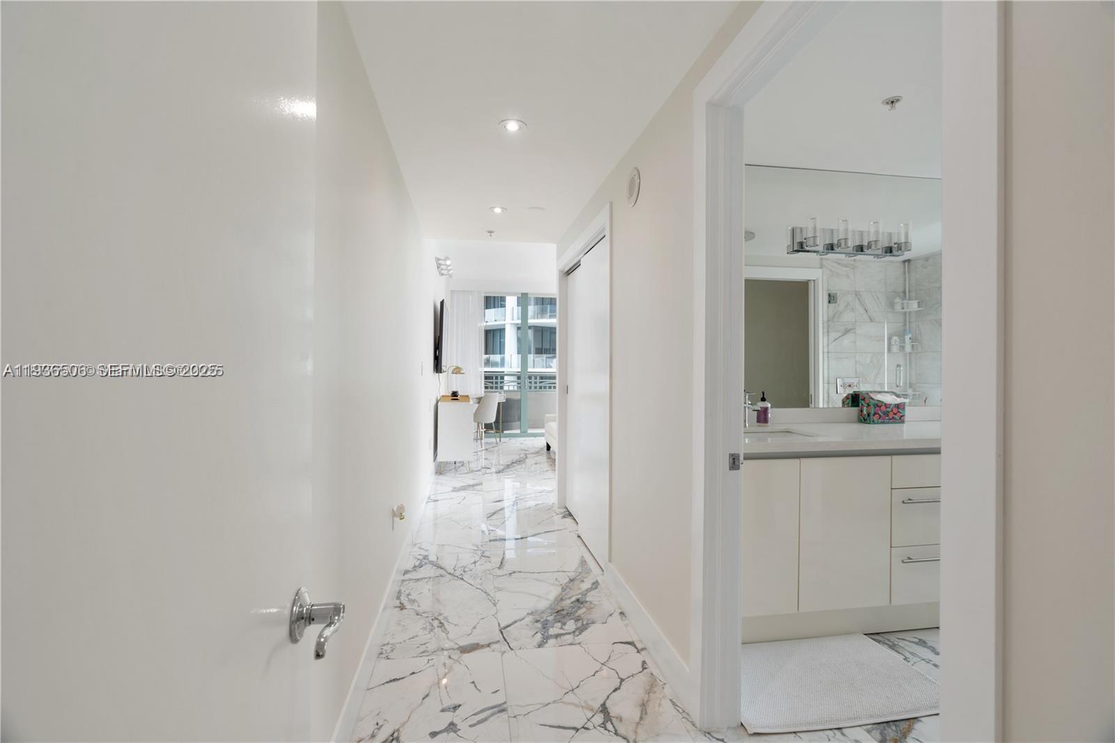 3400 Southwest 27th Avenue, Unit 605 Miami, FL 33133 - Photo 12 of 34 a view of a hallway with bathroom
