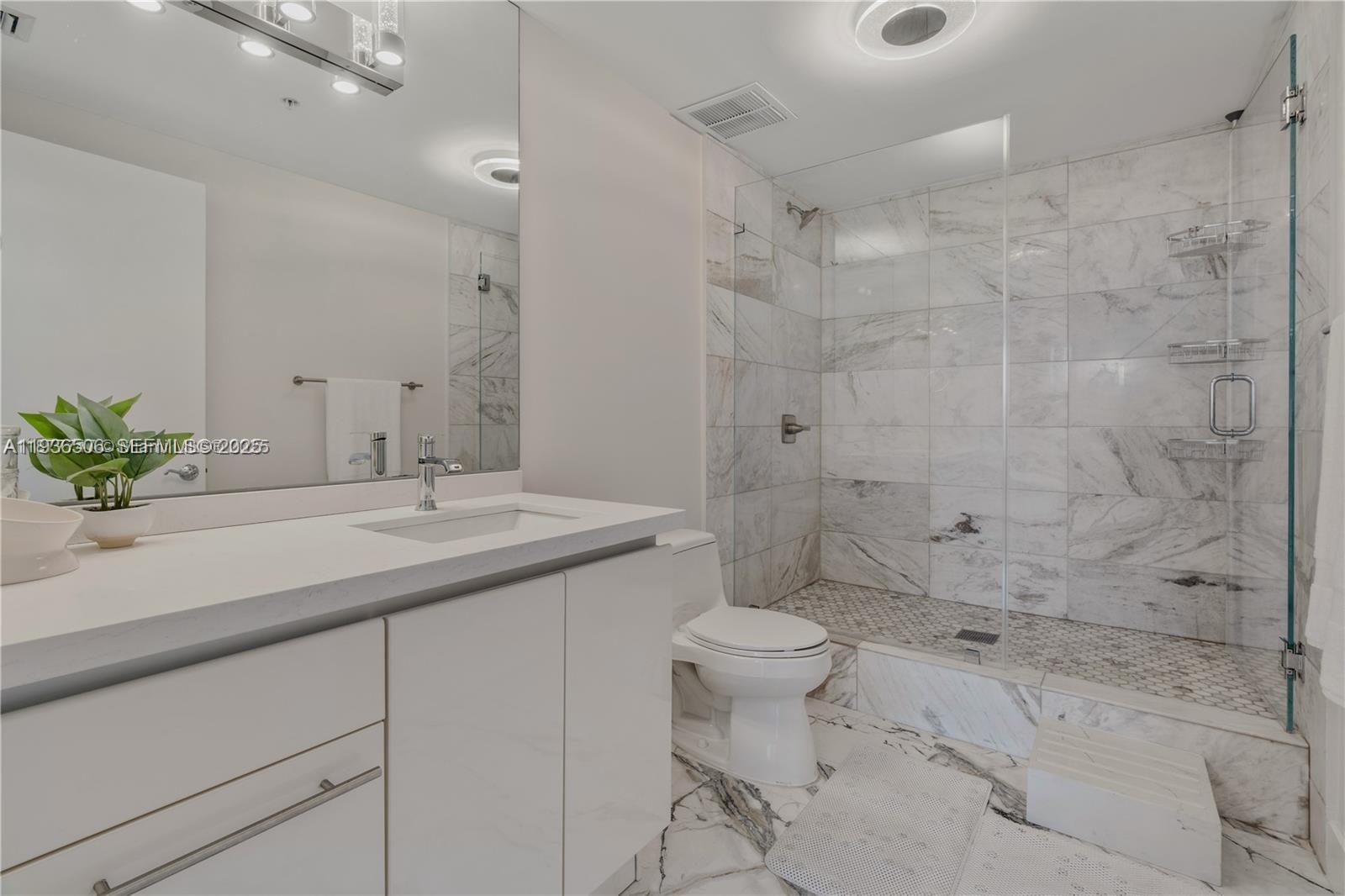 3400 Southwest 27th Avenue, Unit 605 Miami, FL 33133 - Photo 18 of 34 a bathroom with a sink a toilet and shower