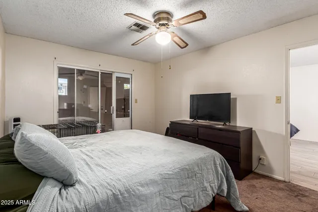 a bedroom with bed and tv