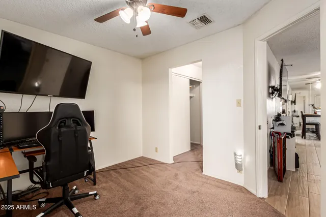 a view of a workspace with furniture and a flat screen tv