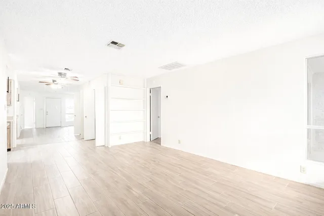 a view of a room with wooden floor
