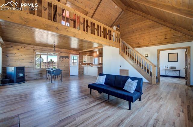 19350 Lemesany Road Calhan, CO 80808 - Photo 10 of 46 Living room with high vaulted ceiling, wooden ceiling, and hardwood / wood-style floors