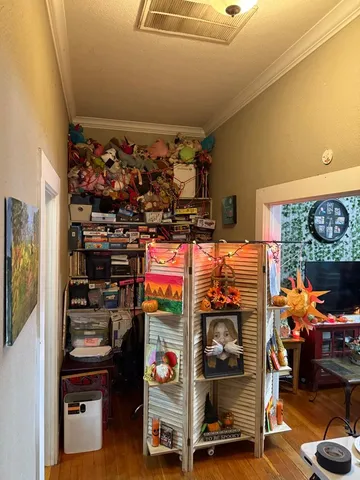 a living room with furniture hard wood floor and a table