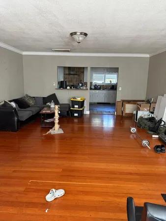 a kitchen with a sink and wooden floor