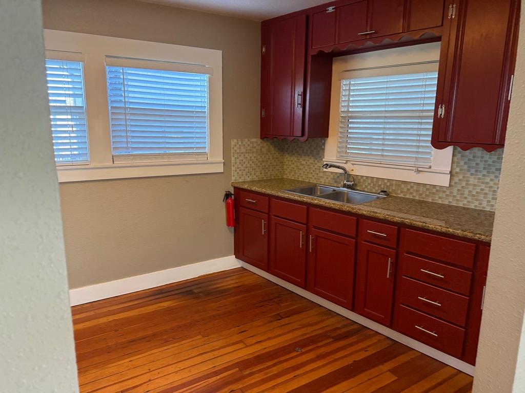 533 Reeves Avenue Yuba City, CA 95991 - Photo 29 of 48 a room with granite countertop wooden cabinets and a sink