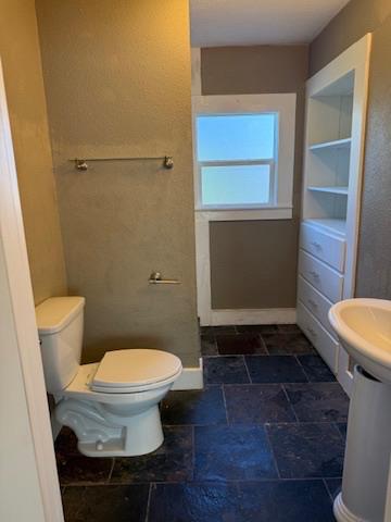 533 Reeves Avenue Yuba City, CA 95991 - Photo 30 of 48 a bathroom with a toilet and a rug