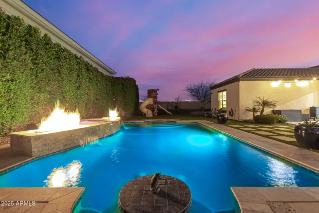 a view of a swimming pool with an outdoor seating and a potted plant