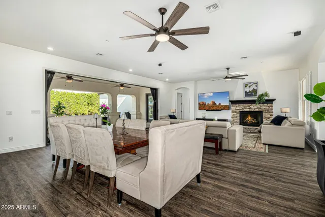 a living room with fireplace furniture and a large window