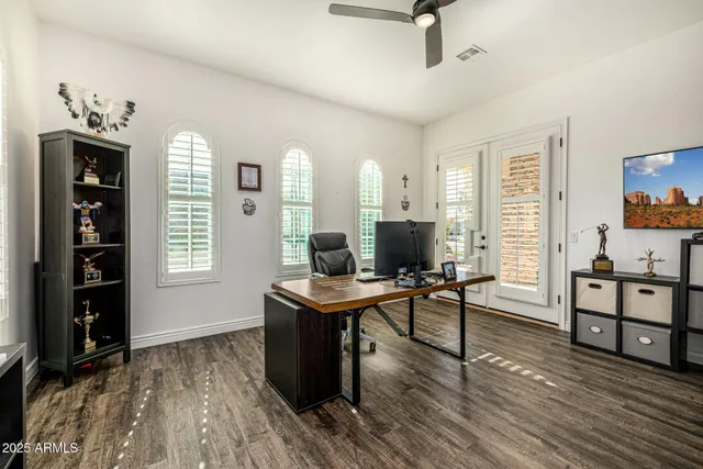 a view of a workspace with furniture window and wooden floor
