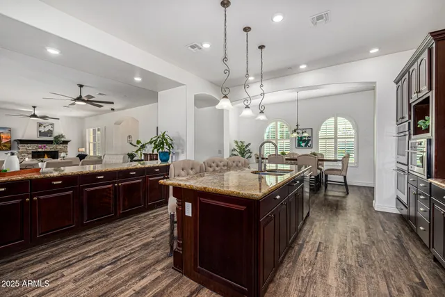 a kitchen with kitchen island granite countertop lots of counter top space and stainless steel appliances