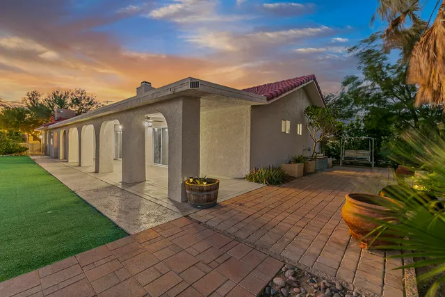 a backyard of a house with outdoor seating