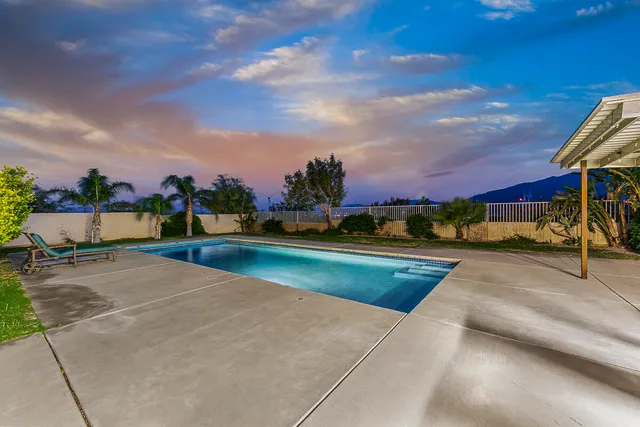 a view of swimming pool with a yard