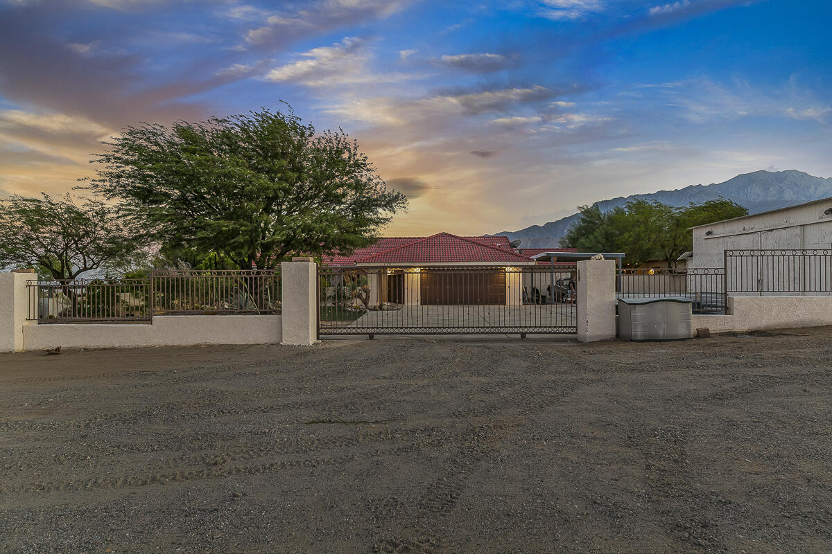 61895 Smoke Tree Road North Palm Springs, CA 92258 - Photo 2 of 88 a front view of a house with a yard and garage