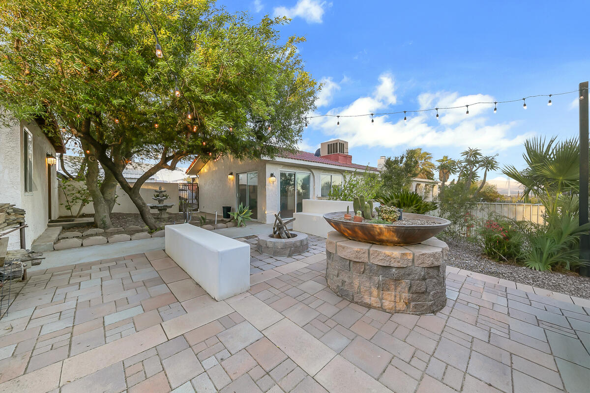 61895 Smoke Tree Road North Palm Springs, CA 92258 - Photo 57 of 88 a view of a patio with couches and table and chairs with wooden fence