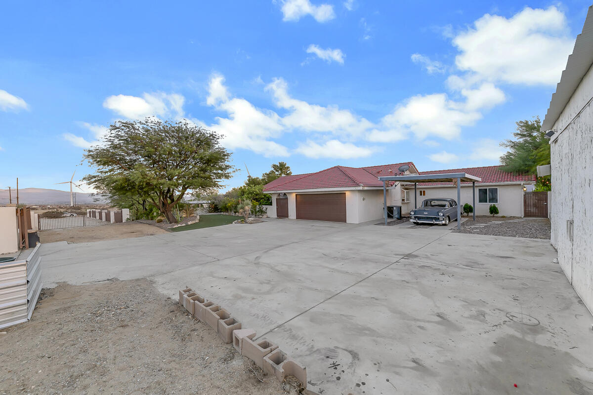 61895 Smoke Tree Road North Palm Springs, CA 92258 - Photo 85 of 88 a front view of a house with a yard and garage