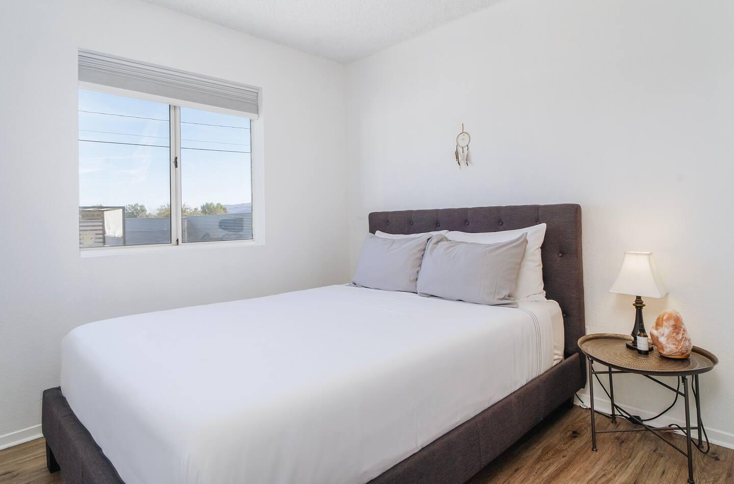 6635 Morongo Road Twentynine Palms, CA 92277 - Photo 18 of 31 a bedroom with a bed and wooden floor