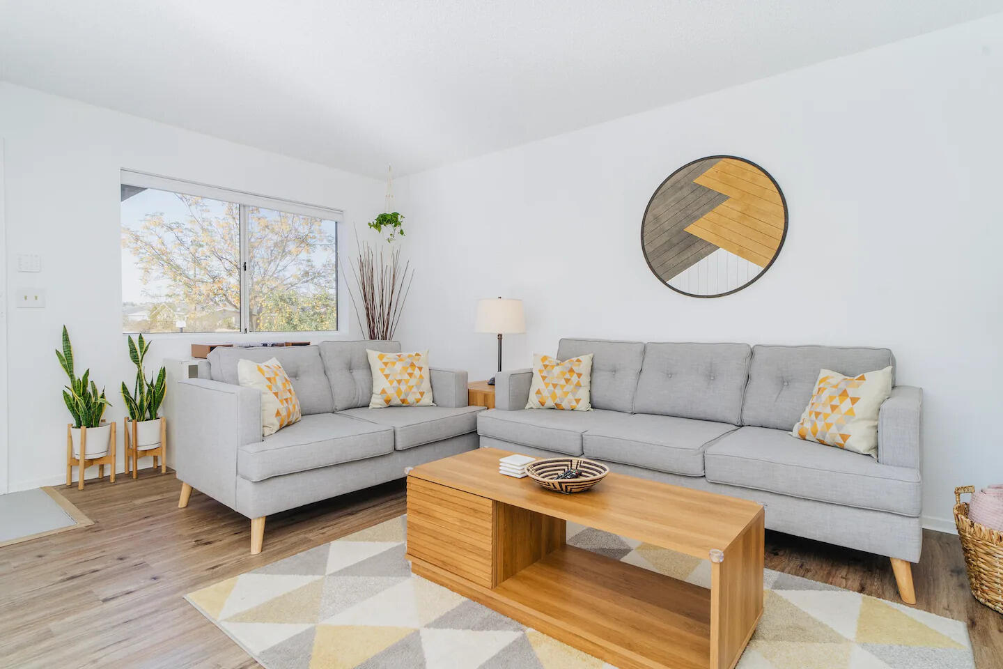6635 Morongo Road Twentynine Palms, CA 92277 - Photo 3 of 31 a living room with a couch and a potted plant