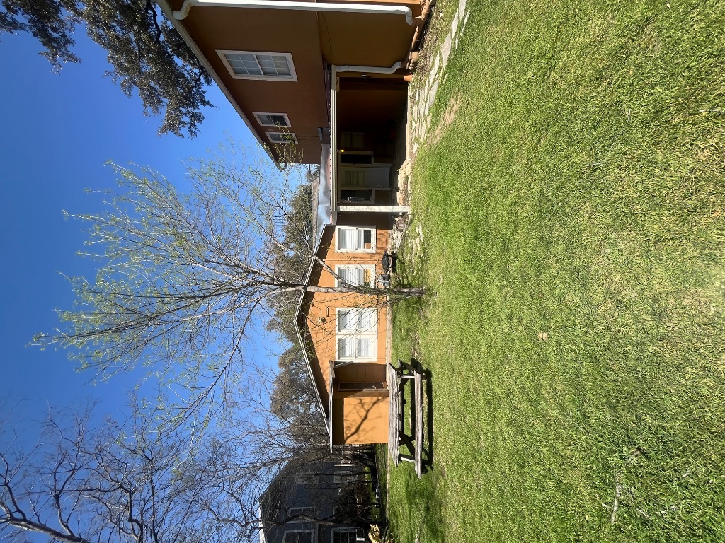 a front view of a house with a yard and a garage