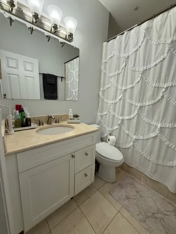 a bathroom with a sink a toilet and mirror