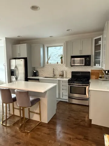 a kitchen with a stove a sink and a refrigerator