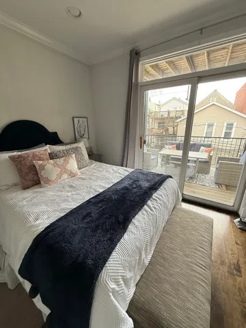 a bedroom with a large bed and a large window