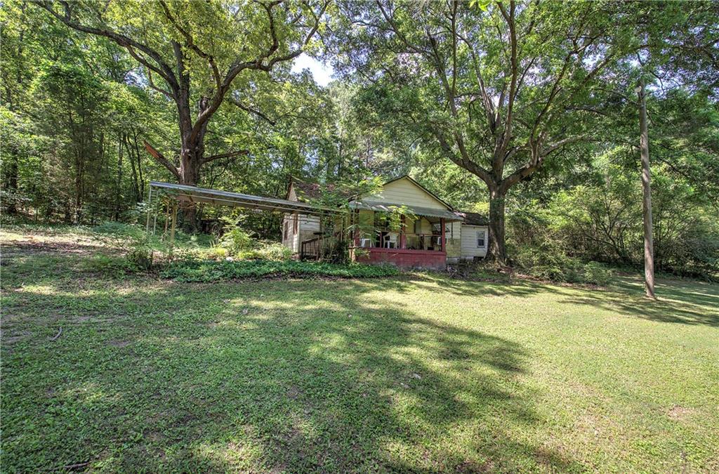 1217 Mission Road Southwest Cartersville, GA 30120 - Photo 1 of 18 a view of a house with a yard
