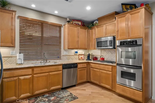 a kitchen with stainless steel appliances granite countertop a sink and cabinets