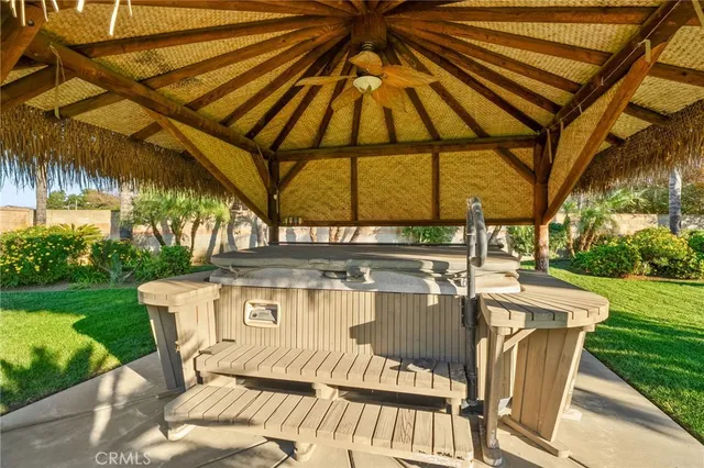 a view of a patio with a table and chairs under an umbrella