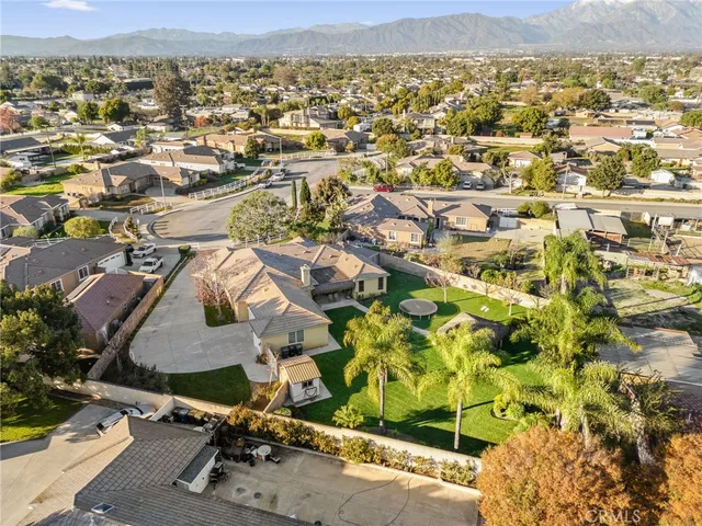 an aerial view of a house with a yard and garden