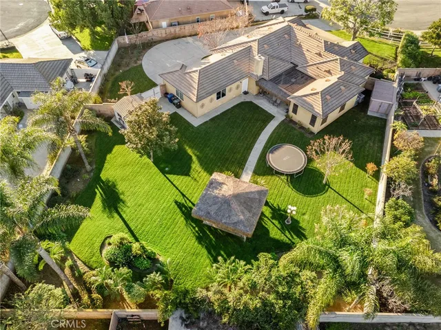 an aerial view of residential house with outdoor space and parking