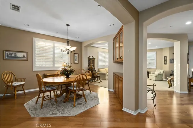 a living room with fireplace furniture and a wooden floor