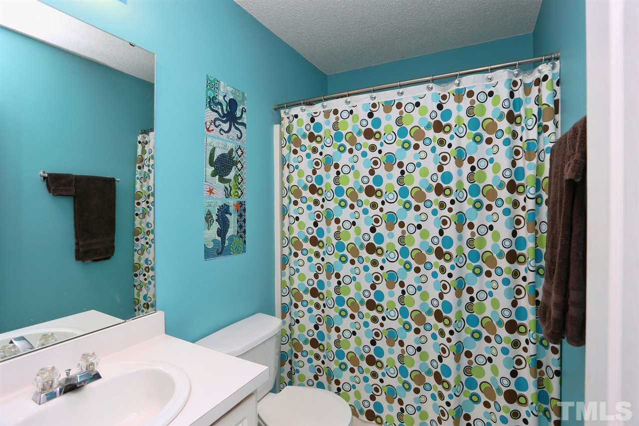 5033 Gable Ridge Drive Durham, NC 27713 - Photo 14 of 25 a bathroom with a sink toilet and shower