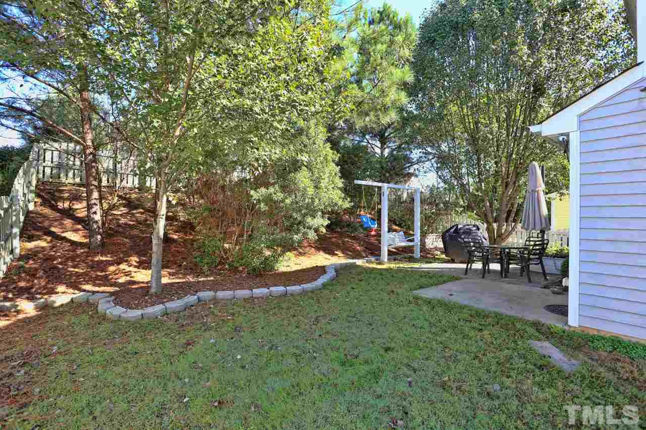 5033 Gable Ridge Drive Durham, NC 27713 - Photo 18 of 25 a view of a house with backyard sitting area and garden