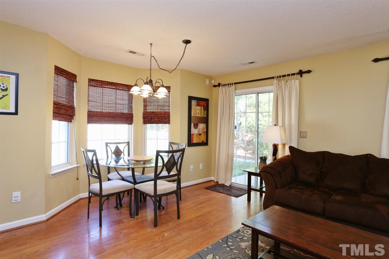 5033 Gable Ridge Drive Durham, NC 27713 - Photo 4 of 25 a living room with furniture a dining table and a chandelier