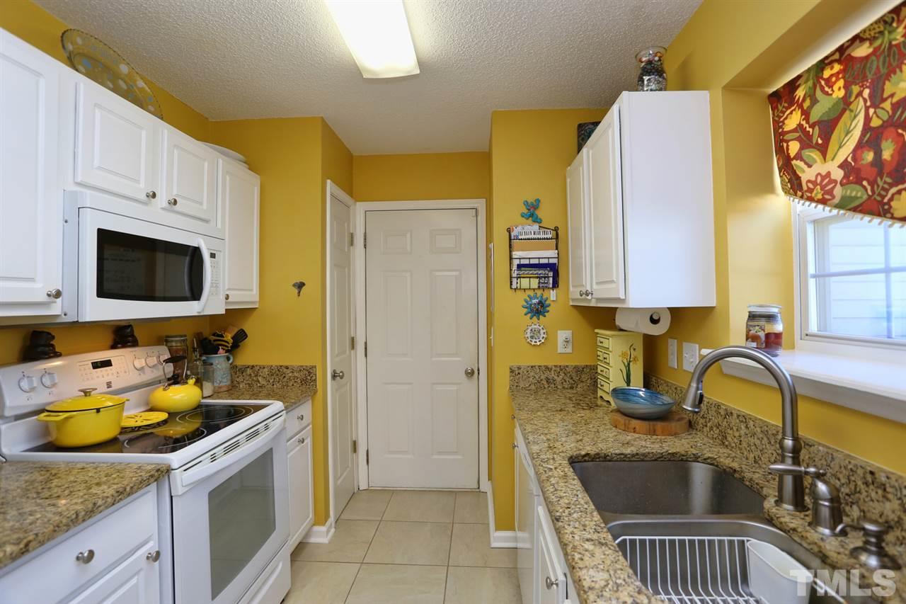 5033 Gable Ridge Drive Durham, NC 27713 - Photo 9 of 25 a kitchen with a sink and a stove top oven