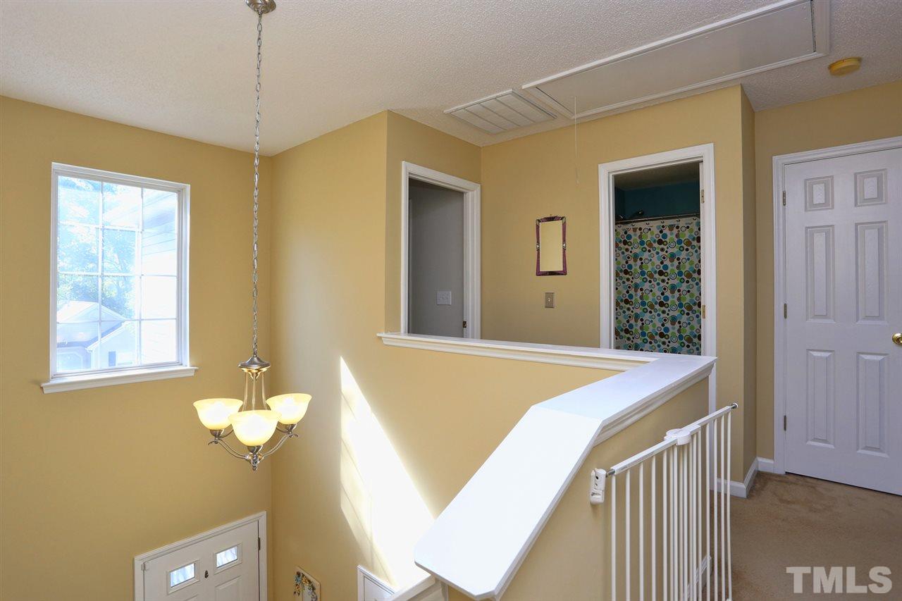 5033 Gable Ridge Drive Durham, NC 27713 - Photo 10 of 25 a bedroom with a bed and a chandelier