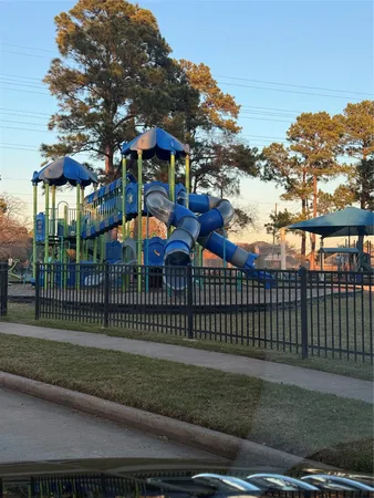 a view of a park with iron fence
