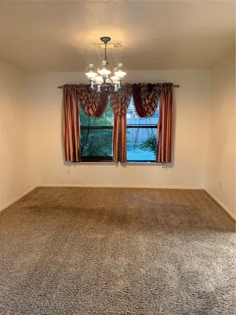 a view of a room with window and chandelier